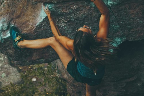 Female climbing a small rock face