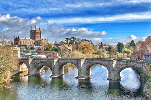 Hereford old bridge over the rive wye, The cathedral is in the background and the sky is a bright shade of blue