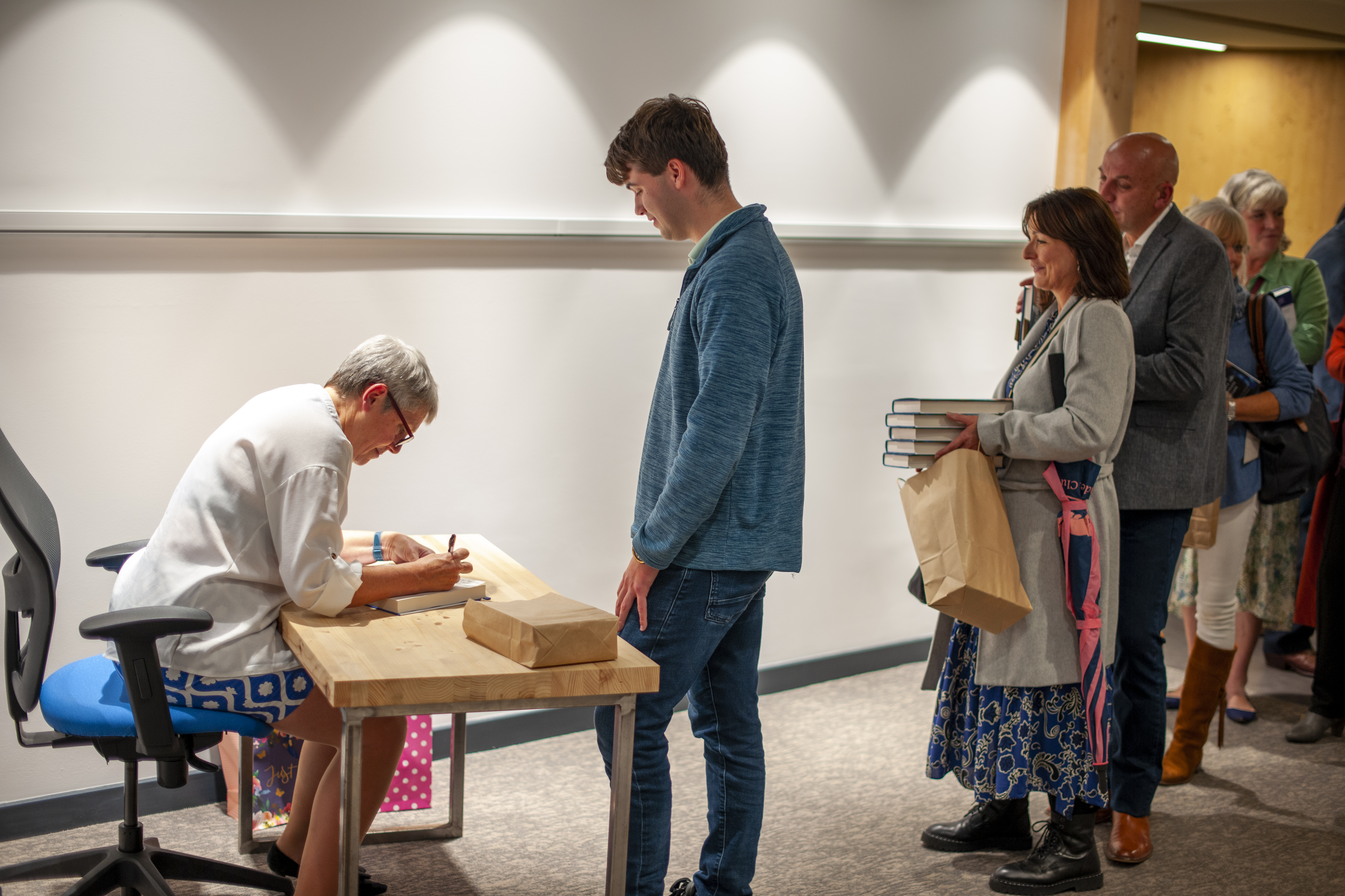 Kate Bingham signing a copy of her new book "The Long Shot" for an NMITE student.