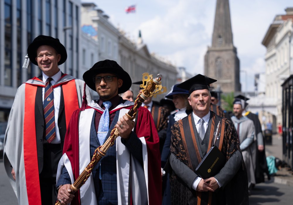 Academic procession walking down hereford high street