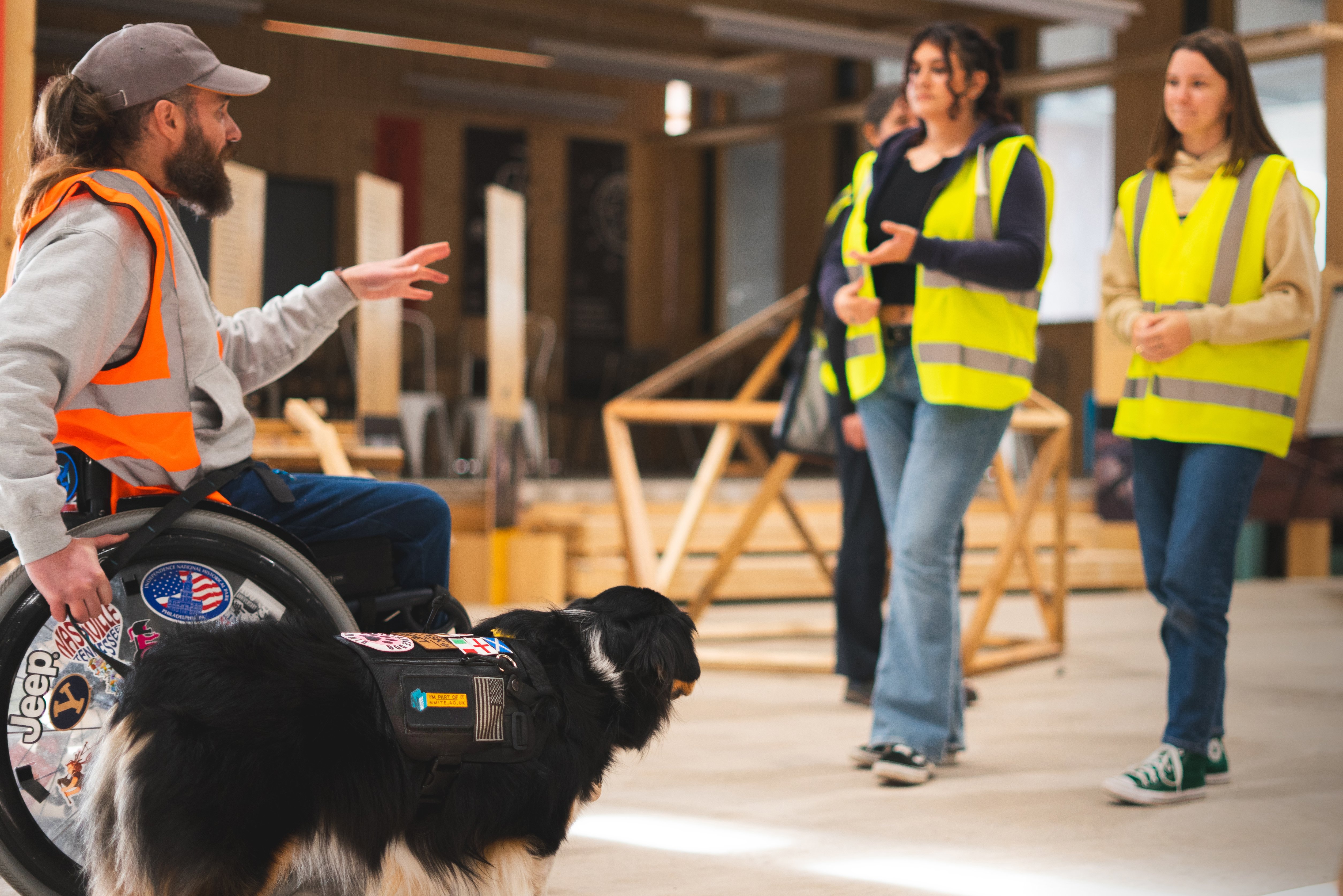 Lecturer in wheelchair with dog teaching NMITE built environment students