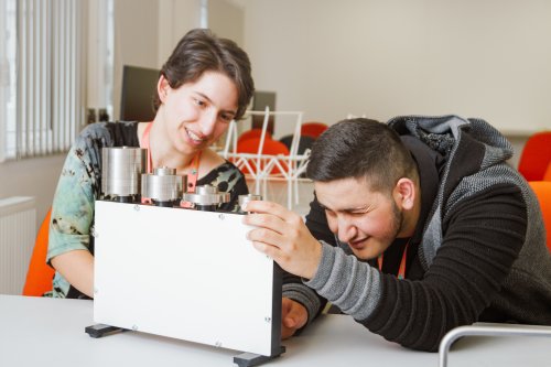 Two NMITE integrated engineering students using laptop in classroom