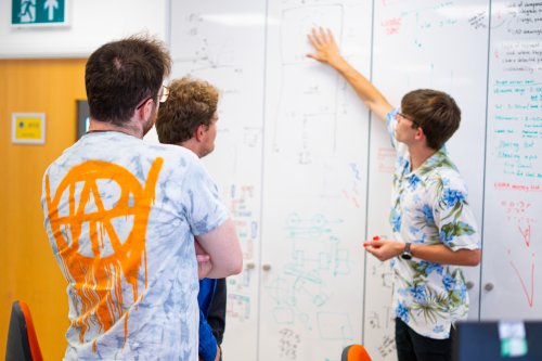 NMITE Students in a studio making calculations on a whiteboard 