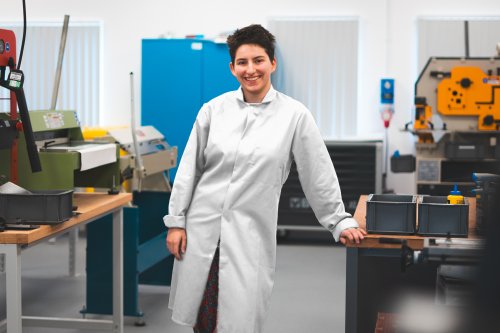 NMIYTE student in the factory with a white lab coat