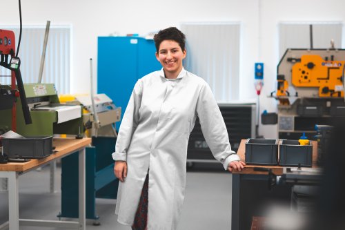 NMITE student in the factory with a white lab coat