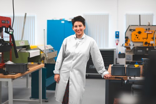 NMIYTE student in the factory with a white lab coat