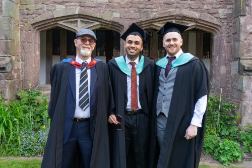 2 students and a lecturer standing side by side 