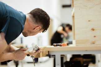 A student wood working for NMITE's BSc Sustainable Built Environment Degree