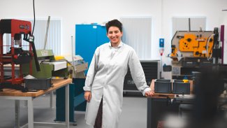 NMIYTE student in the factory with a white lab coat