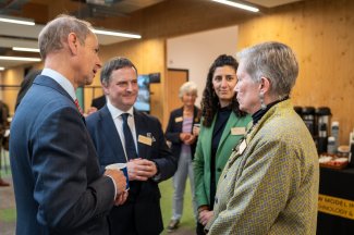Two men speaking to two women