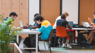 A group of students at desks studying